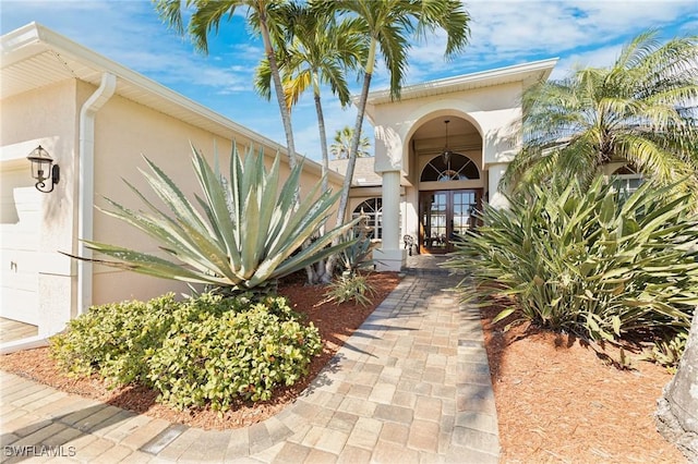 property entrance with french doors and stucco siding