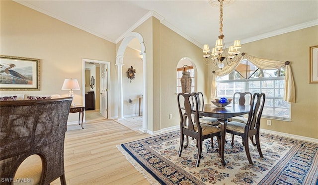 dining room with light wood finished floors, arched walkways, a wealth of natural light, and a notable chandelier