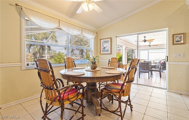 tiled dining space with ornamental molding, lofted ceiling, a healthy amount of sunlight, and ceiling fan