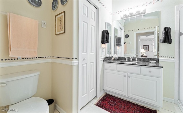 bathroom featuring a shower, tile patterned flooring, vanity, and toilet