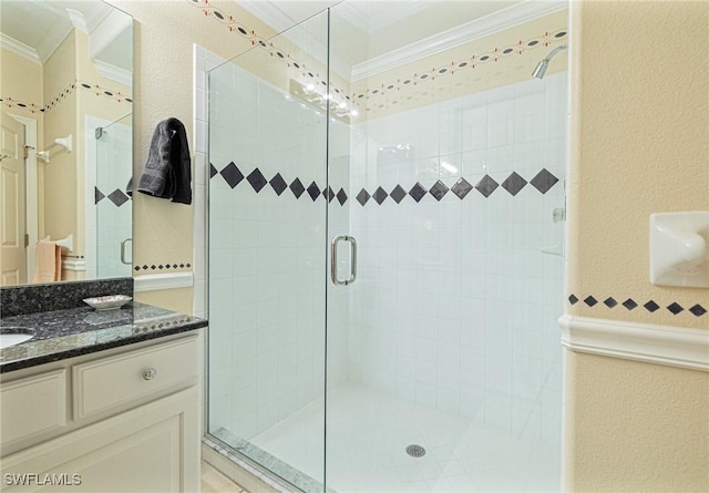 bathroom with ornamental molding, vanity, and walk in shower