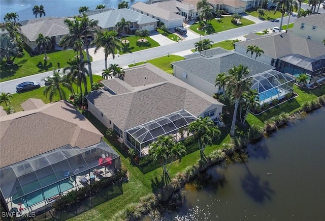 drone / aerial view with a water view and a residential view