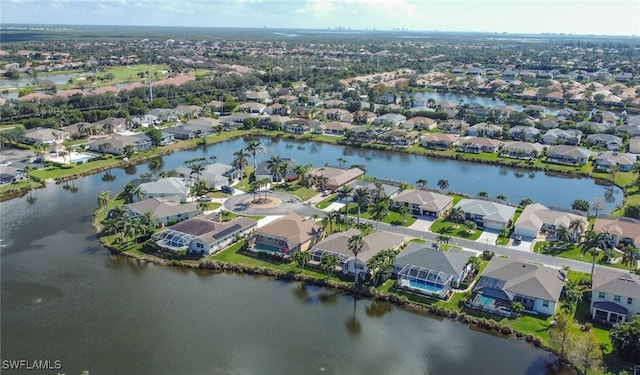 birds eye view of property with a residential view and a water view