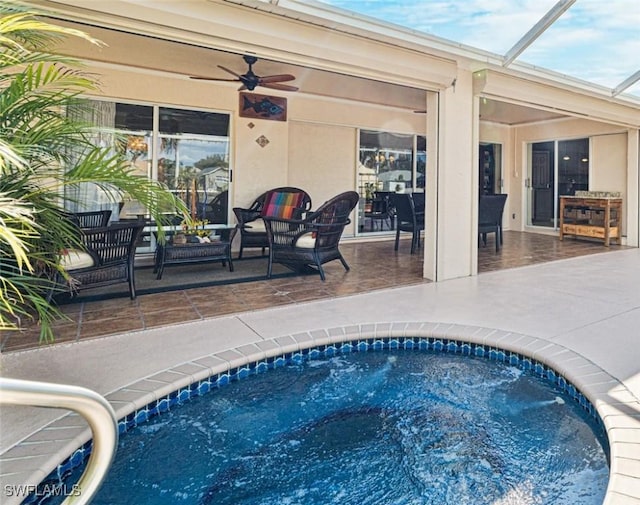 view of pool featuring a patio, an in ground hot tub, and ceiling fan