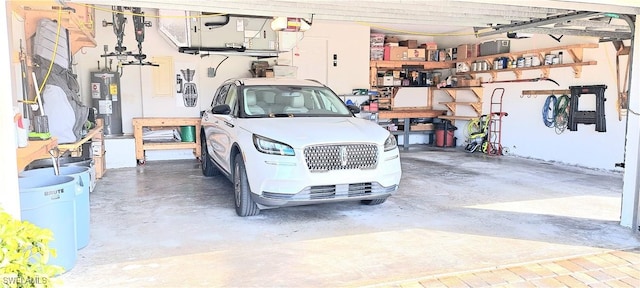 garage featuring water heater and a garage door opener