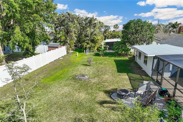 view of yard with an outdoor fire pit and fence