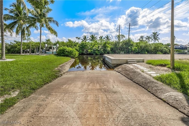 view of home's community featuring a water view and a yard