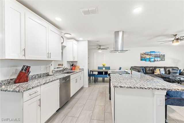 kitchen with visible vents, open floor plan, island exhaust hood, white cabinetry, and stainless steel dishwasher