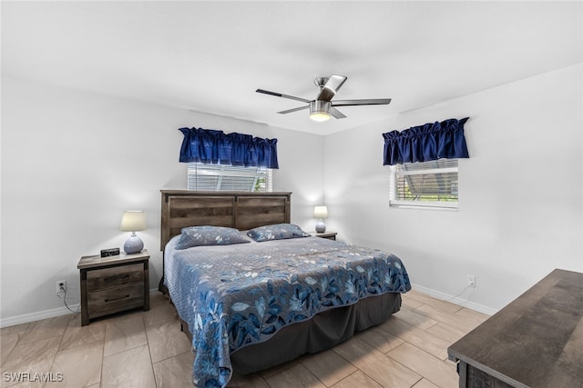 bedroom with wood finish floors, a ceiling fan, and baseboards