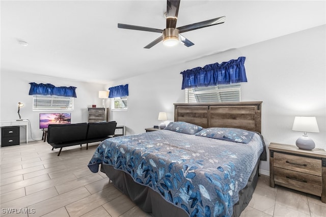 bedroom with a ceiling fan and baseboards