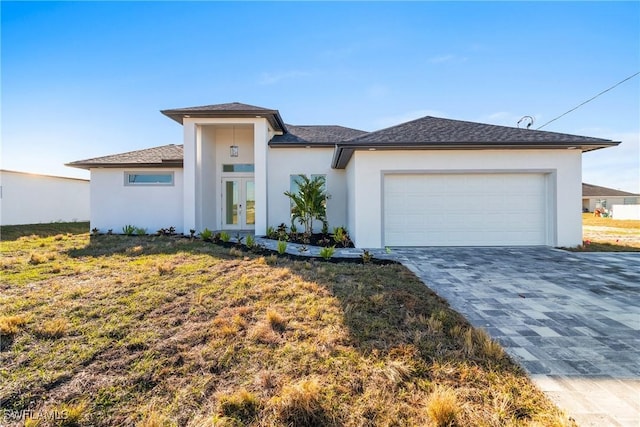 view of front of property featuring a garage and a front lawn