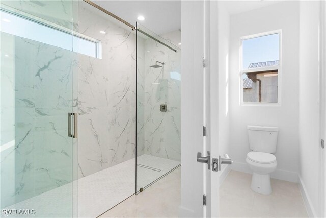 bathroom featuring tile patterned flooring, toilet, and walk in shower