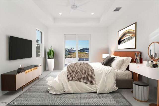 bedroom with access to outside, ceiling fan, and a tray ceiling