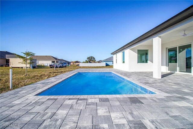 view of swimming pool featuring ceiling fan and a patio