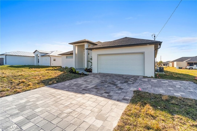 view of front of home with a garage and a front lawn