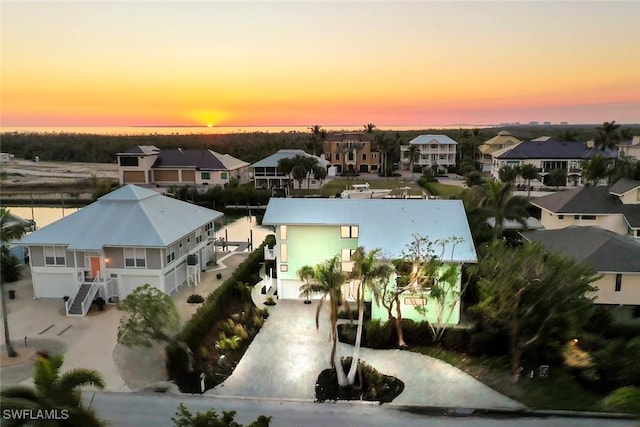 aerial view at dusk with a water view