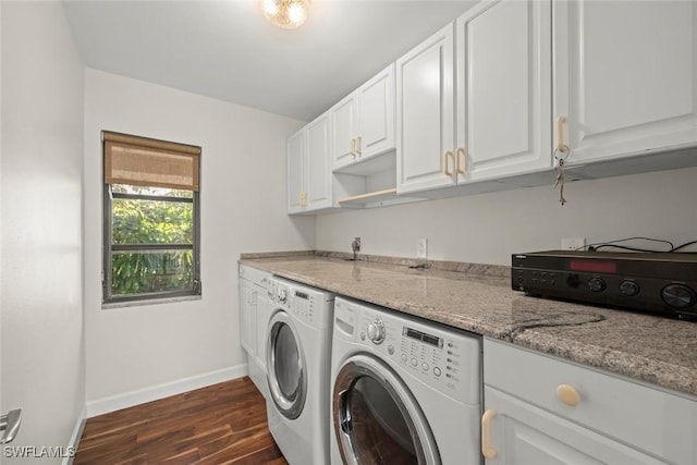 washroom featuring laundry area, baseboards, dark wood-type flooring, and washing machine and dryer