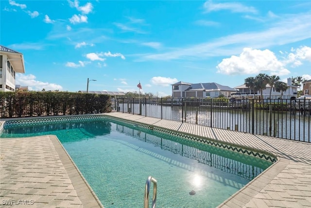 view of pool featuring a water view, fence, a residential view, and a fenced in pool