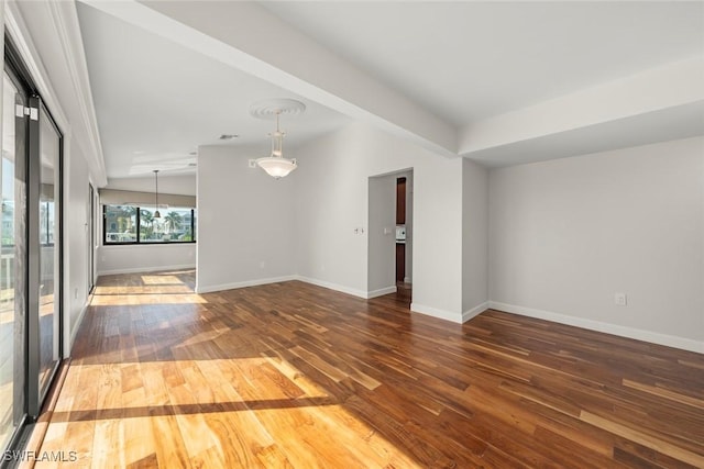 unfurnished room with baseboards and hardwood / wood-style flooring