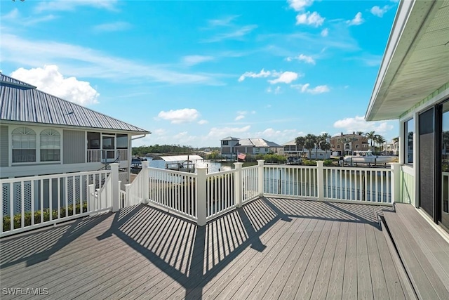 wooden terrace featuring a water view
