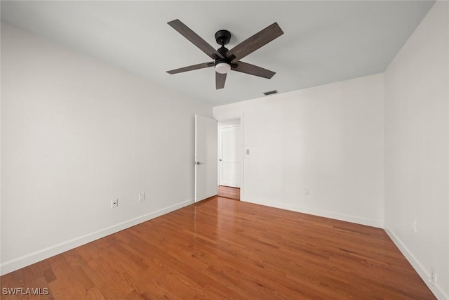 empty room featuring hardwood / wood-style flooring and ceiling fan