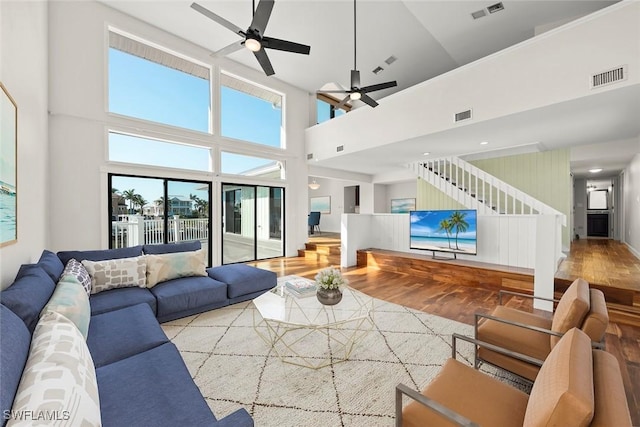 living room featuring visible vents, wood finished floors, and ceiling fan