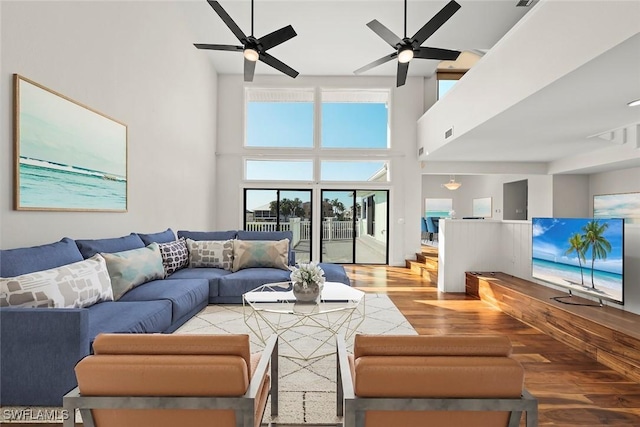 18292 Deep Passage Ln, Fort Myers Beach, FL 33931 - living area featuring wood finished floors, a ceiling fan, and a high ceiling