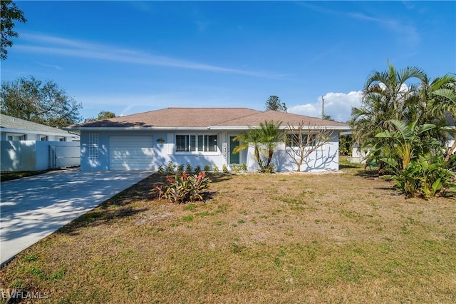 ranch-style home featuring a garage and a front lawn