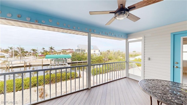 sunroom / solarium featuring ceiling fan