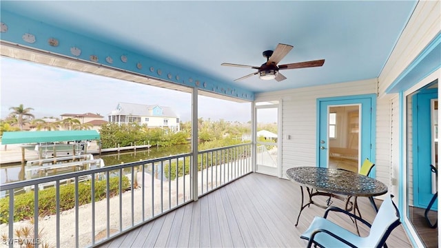 sunroom featuring ceiling fan