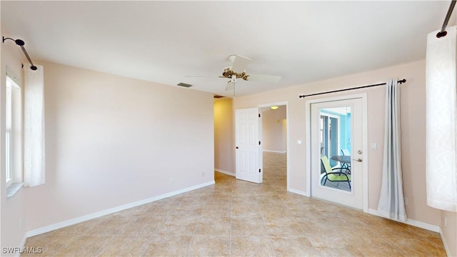 empty room featuring ceiling fan and a healthy amount of sunlight