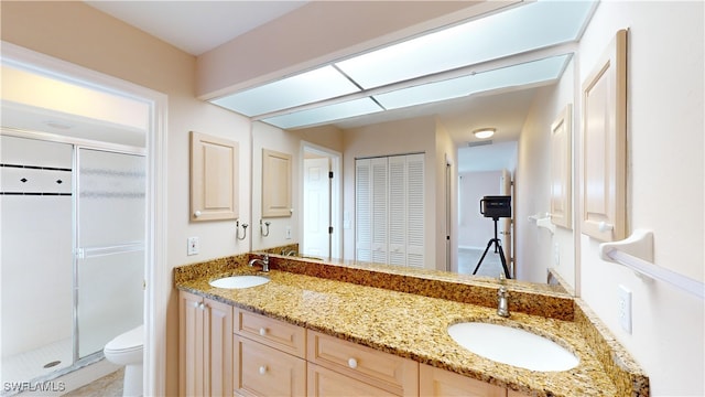 bathroom featuring vanity, toilet, and walk in shower