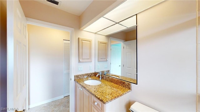 bathroom with vanity and toilet