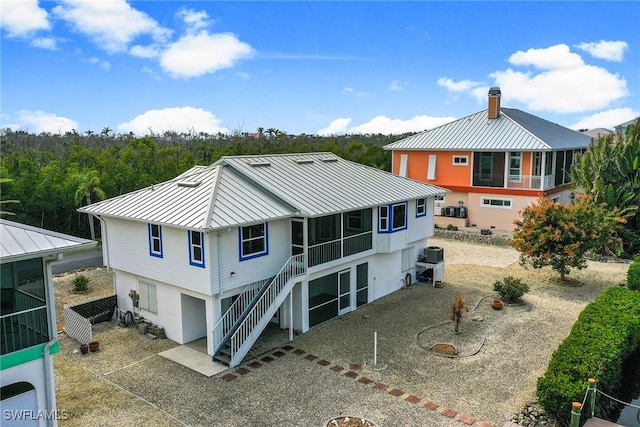 back of house with a sunroom and central air condition unit