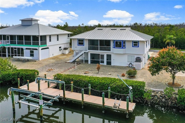 back of property featuring a water view and central AC unit