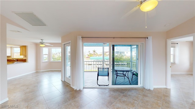 doorway to outside featuring ceiling fan and light tile patterned floors