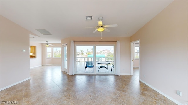 unfurnished room with light tile patterned flooring and ceiling fan