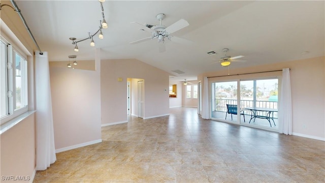 spare room featuring vaulted ceiling, rail lighting, and ceiling fan