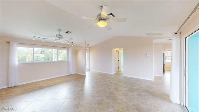 spare room featuring ceiling fan, track lighting, and vaulted ceiling