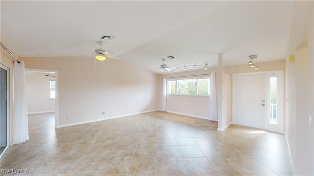 tiled empty room with ceiling fan and vaulted ceiling