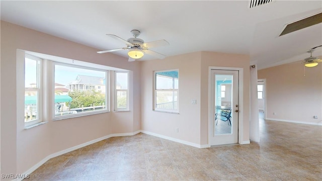 empty room with a wealth of natural light and ceiling fan