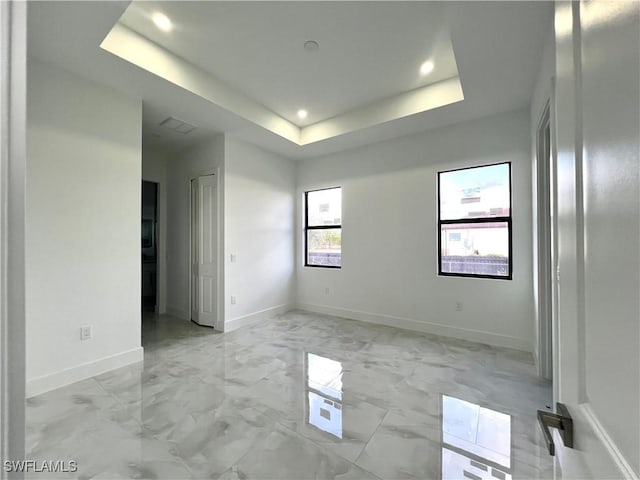 spare room featuring a tray ceiling