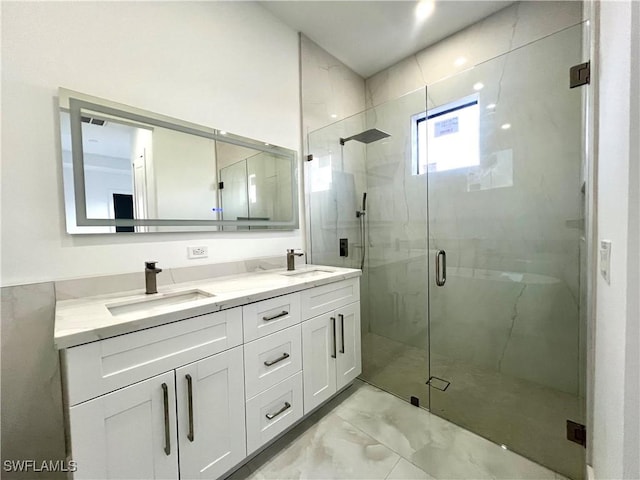 bathroom featuring vanity and an enclosed shower