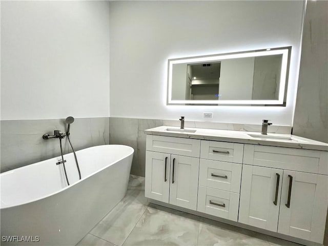 bathroom featuring vanity and a washtub