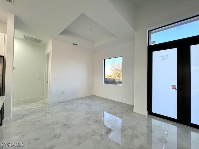 unfurnished room with a raised ceiling