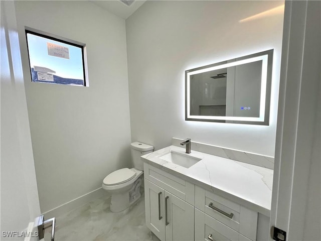 bathroom with vanity and toilet