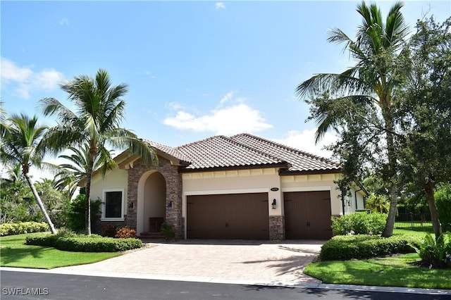 mediterranean / spanish-style home with a garage