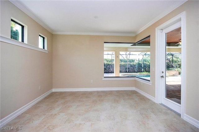 empty room with a sunroom, plenty of natural light, and baseboards