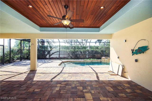 view of swimming pool featuring a pool with connected hot tub, a lanai, a patio, and ceiling fan