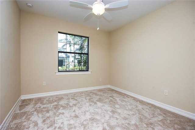 unfurnished room featuring carpet, a ceiling fan, and baseboards